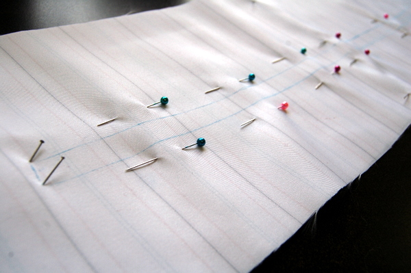 use lots of pins on either side of the zipper stitching line