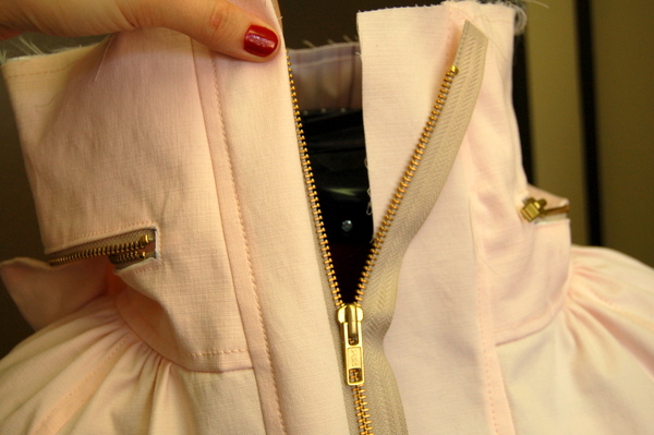 when the seam allowance is turned in, the zipper tab is on the right side!